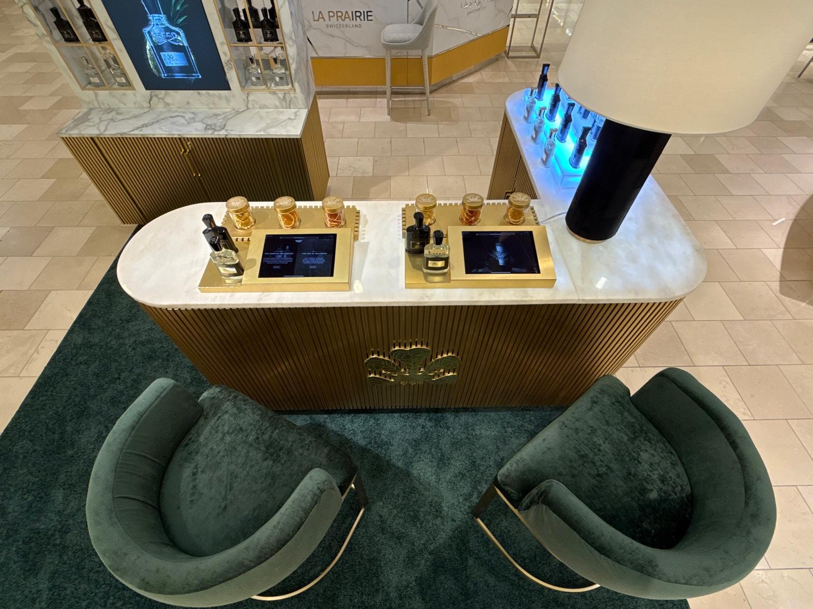 Aerial overhead view of Creed 1760 counter with velvet seating and digital displays