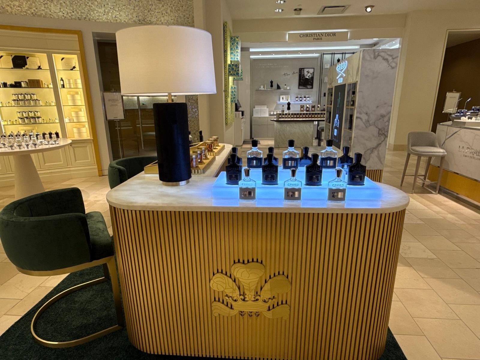 Creed 1760 kiosk with Christian Dior boutique visible in background