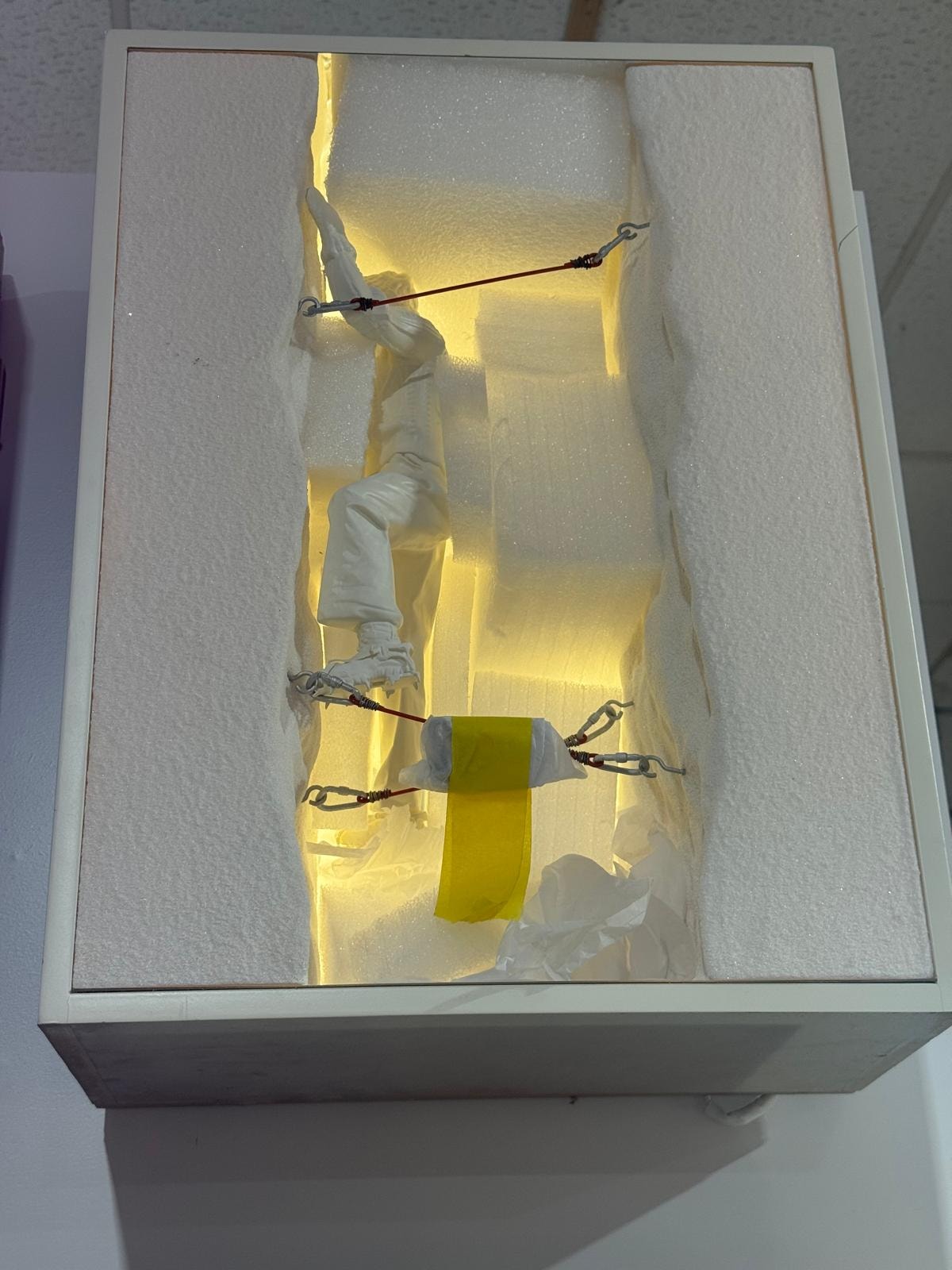 Custom fabricated orange display figure in white box showcase
